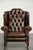 This elegant cowhide Chesterfield wing armchair is crafted in a beautiful dark brown color and is finished with decorative...