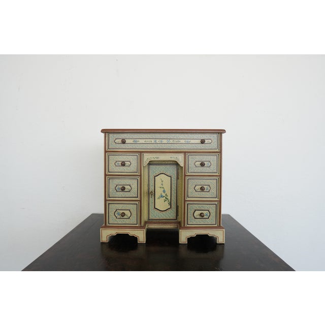 This vintage Maitland-Smith hand painted miniature secretary desk jewelry cabinet, dating to the late 20th century,...