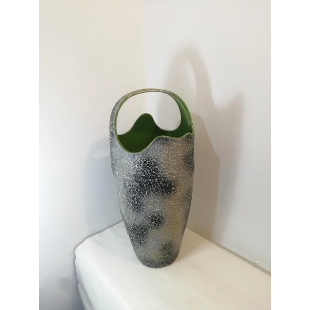 Characteristic umbrella stand in colored aluminum. with a modernist shape in the style of Antonia Campi, the surface...