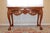 Enhance your space with this vintage mahogany console table, a stunning representation of classic Chippendale design....