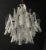 Mid century modern eight-light white and clear Murano glass petals chandelier. There are three tiers and 32 glass petals,...