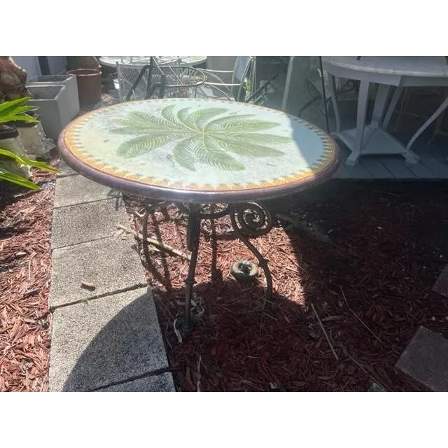 This is a very nice also very heavy iron base with stone glazed top, with palm leaf's birds and insects, very good...