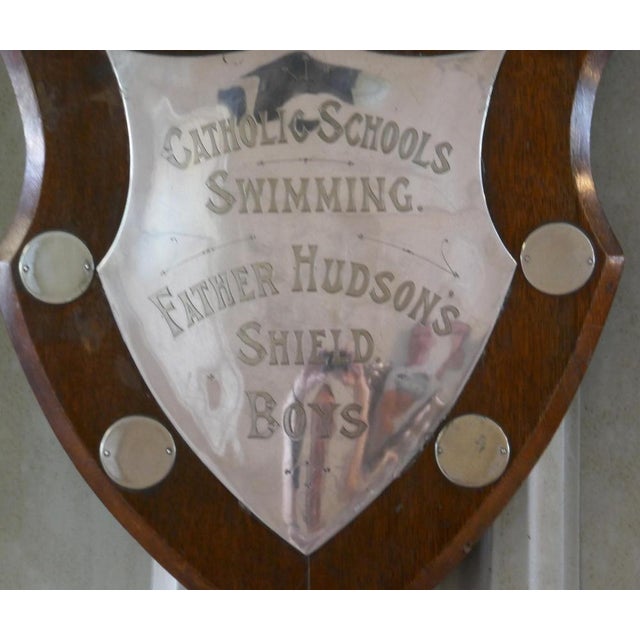 Traditional shield swimming trophy the is a traditional golden oak shield has a large silver plated mount, in the centre...