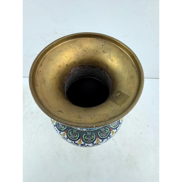 A large Chinese cloisonne vase decorated with multicolored lotus and foliate scrolls on a white enamel ground, bordered by...