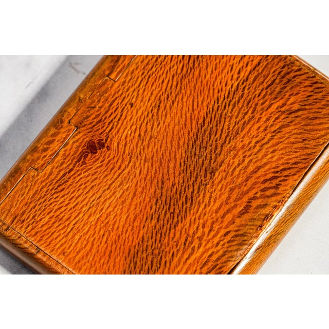 Dating to the early 20th century, this charming antique wooden snuff box is a wonderful example of understated...