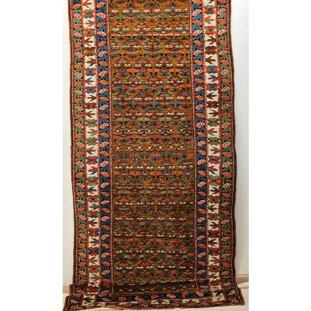 This authentic antique Persian Kurdish camel hair runner, dating to the early 1900s. . Handwoven from lustrous camel hair...