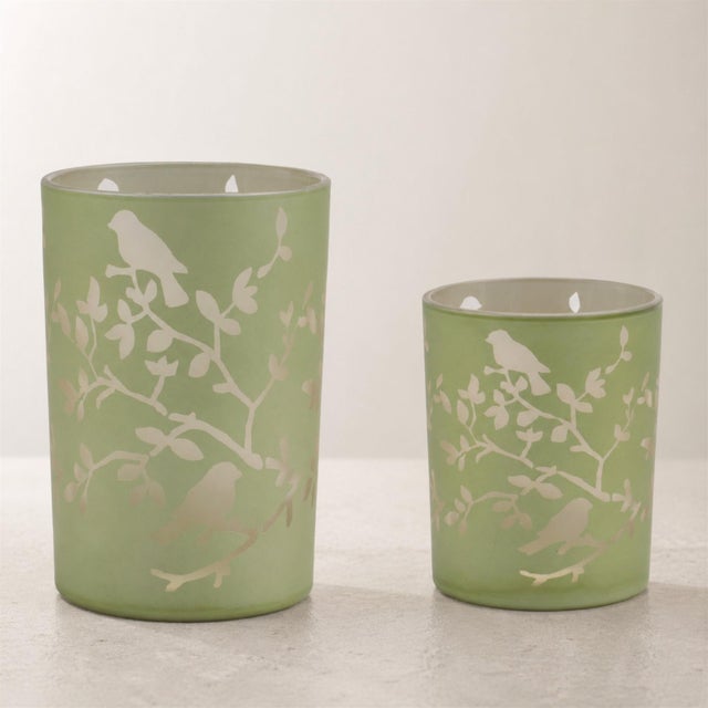 Add a touch of nature-inspired elegance to your home with the Frosted Floral Bird Candle Holder Set. Featuring warm green...