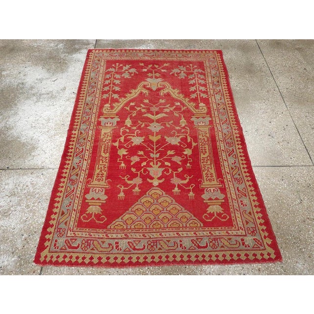 This Early 20th century Turkish Oushak rug, measuring 3' 8" x 5' 8", is a graceful example of Anatolian weaving artistry....