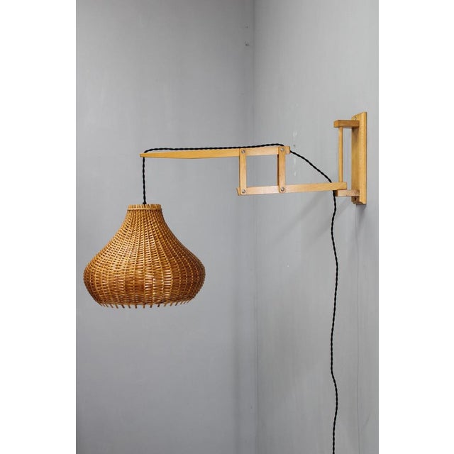 A refined mid-century adjustable wall lamp designed and produced by lipta in czechoslovakia during the 1970s. Crafted from...