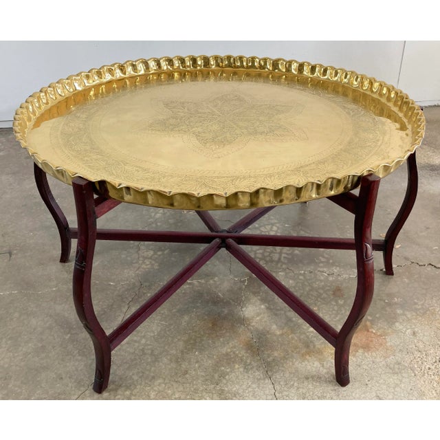 Oversized vintage Moroccan style scalloped brass tray table on collapsible wood bamboo motif base. Large tray top is...
