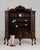 This bookcase/cabinet carries genuine presence, its dark mahogany, glass doors, 3 drawers, claw feet immediately setting...
