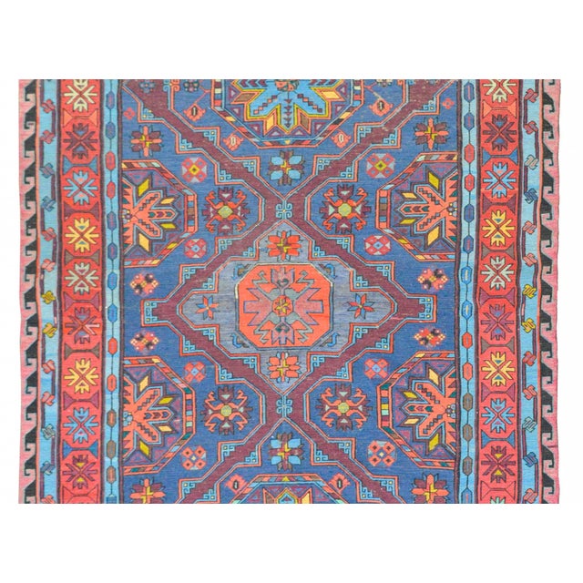 A fantastic bold vintage Afghani Soumak rug with three large diamond medallions with a stylized floral motif amidst a...