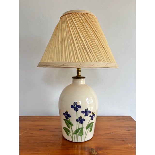 Hand-painted studio pottery lamp featuring happy purple violets. No maker's mark. Most items found at Pub & Oasis are...