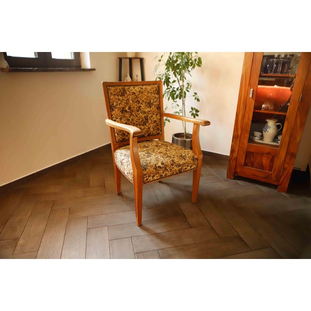 This elegant vintage salon armchair was manufactured in Czechoslovakia around the mid-20th century, most likely between...