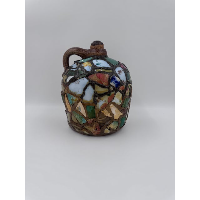 Authentic antique memory jug featuring an allover surface of embedded porcelain and ceramic shards, including floral china...