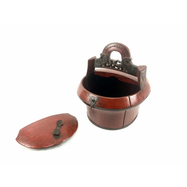 A small, round antique hand-made Chinese lunch box with bronze fittings and beautiful coloring and patina. Sourced from an...