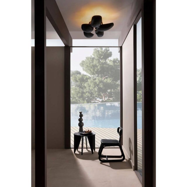 With five sculptural pod-shaped shades, the Theo semi-flush mount is a bold accent in any space. Created in blackened iron...