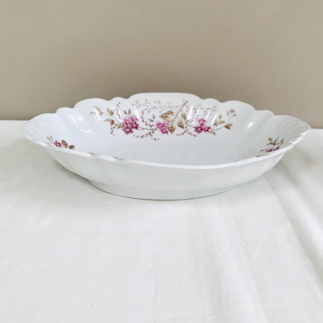 Antique, deep, oval serving dish with scalloped borders. Hand decorated white porcelain with deep green and fuchsia...