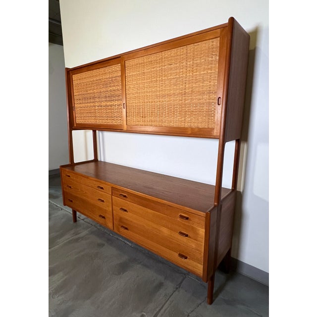 Sideboard credenza in teak with six drawers topped by a cabinet with cane door fronts, designed by Hans Wegner for Ry...