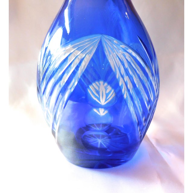 This is a tall blue cut to clear Decanter or bottle or vase with no stopper. The bottle measures 11.25 inches tall and is...