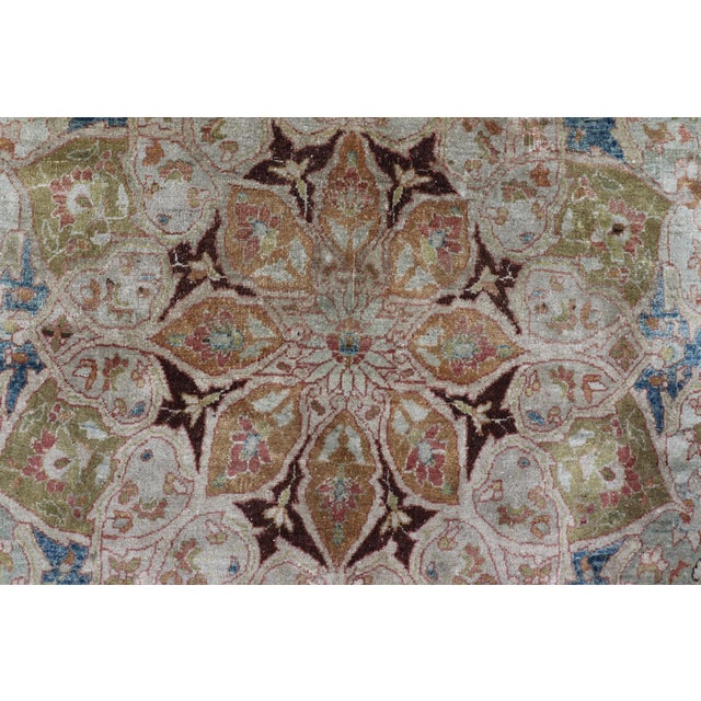 Large antique Persian Mashhad carpet with colorful floral and medallion design. Persian Mashhad floral design. Keivan...