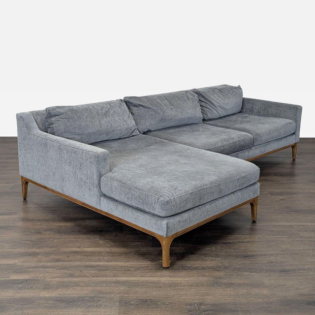 This West Elm sectional features a soft gray fabric and a spacious chaise for extra comfort. The modern design has clean...