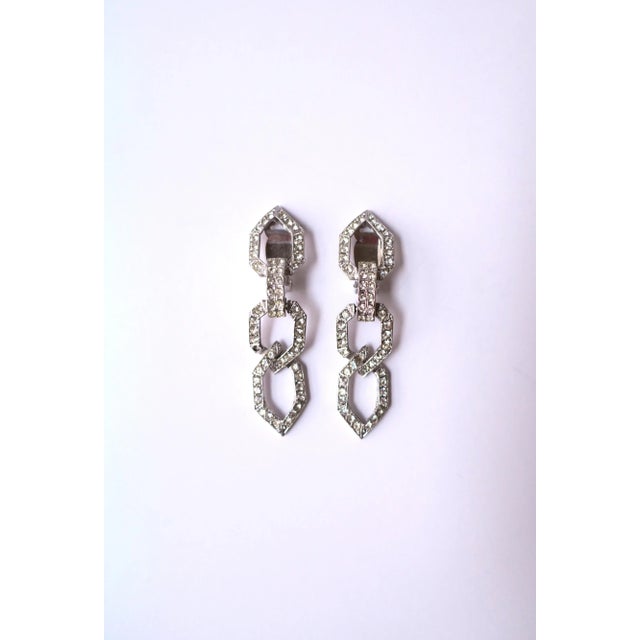 A beautiful and rare pair of vintage Kenneth Jay Lane faux-diamond rhinestone dangle clip-on earrings, circa 1980s. Made...
