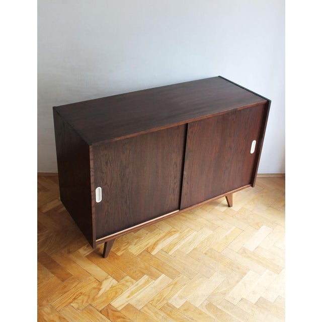 Designed by Jiří Jiroutek and produced by Interiér Praha in 1960s Czechoslovakia, this original U-450 sideboard is...