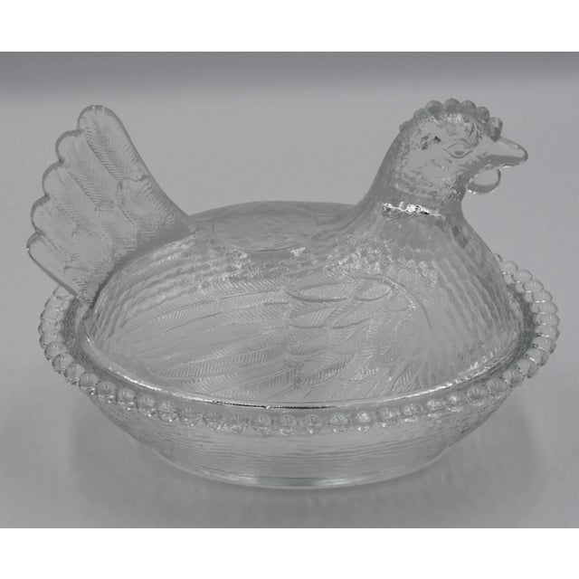 The Vintage Indiana Clear Glass Hen on Nest Chicken Glass Covered Dish is a charming and nostalgic piece that adds a touch...
