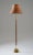 Simple and elegant floor lamp in teak and brass by Boréns, Sweden. The lamp features a heavy brass base, supporting a rod...