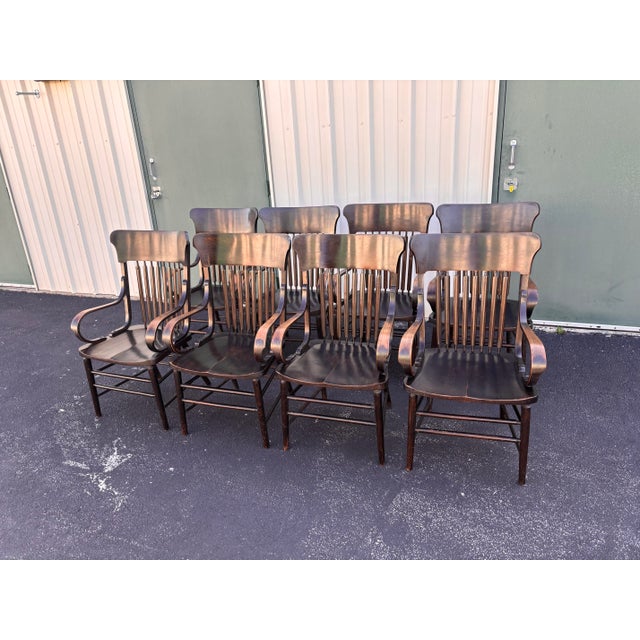 Antique set of arm chairs from the early 20th century and full of well-loved and aged character. Each Oak charm chair is...
