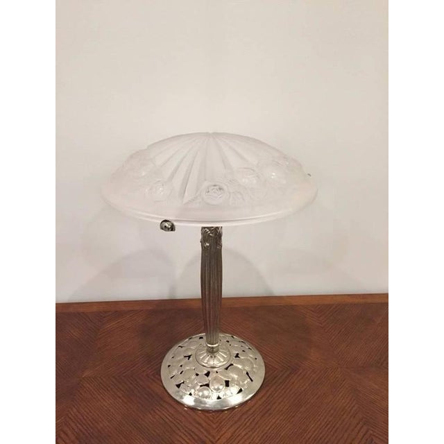 A stunning French Art Deco table lamp created in the 1930s signed by Degue. Having clear and frosted glass shade with...