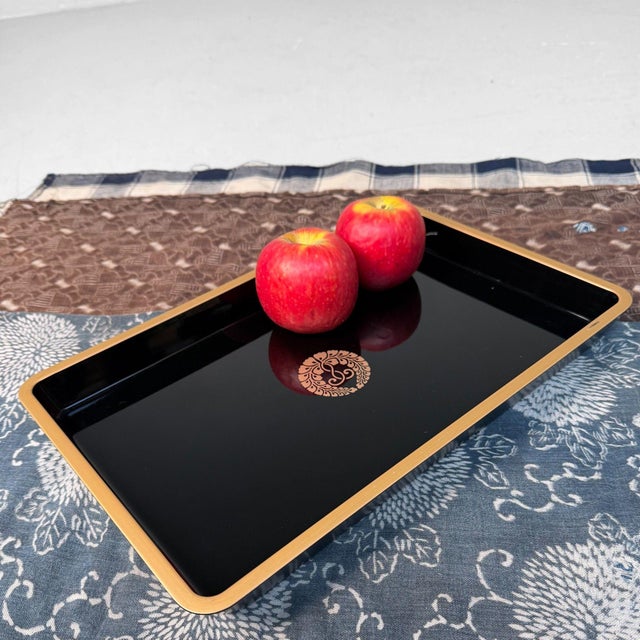 This refined Japanese obon tray is entirely finished in deep black urushi lacquer. Its high gloss and clean, slightly...