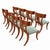 A striking set of 8 walnut Klismos dining chairs featuring beautifully figured wood grain, sweeping curved backrests, and...