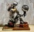 Vintage handcrafted steampunk robot table lamp material: mixed metal, repurposed automotive parts, carpenter’s plane,...