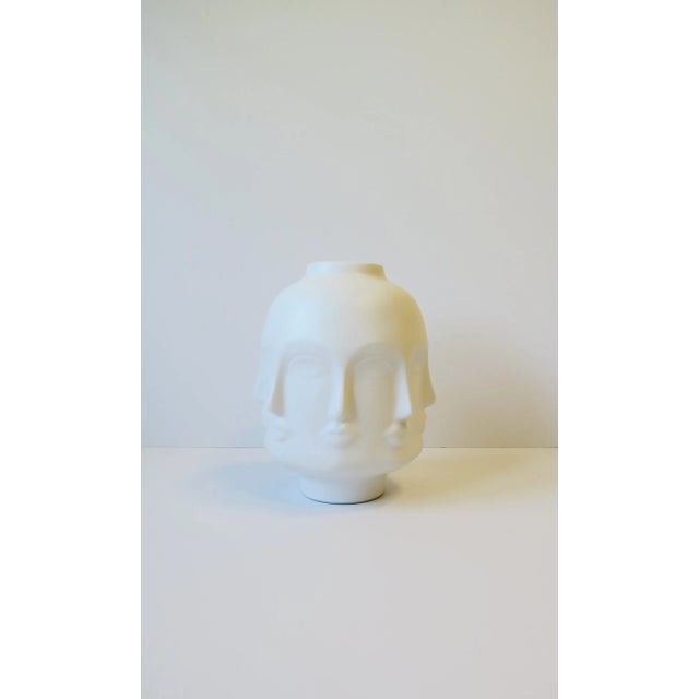 A relatively large white ceramic face or 'faces' vase, in the Surrealist/Surrealism style, circa early-21st century. This...