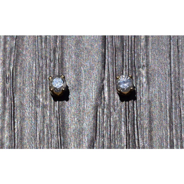 The Boweya: Vintage Yellow Gold Natural Diamond Studs. The stud earrings feature two round brilliant-cut natural diamonds...