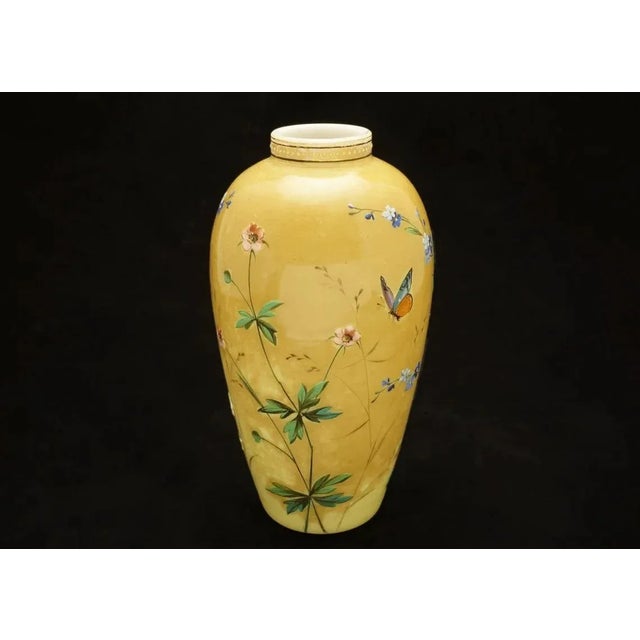 This exquisite antique art glass vase with a mottled amber-yellow exterior and white cased glass interior. The vase is...
