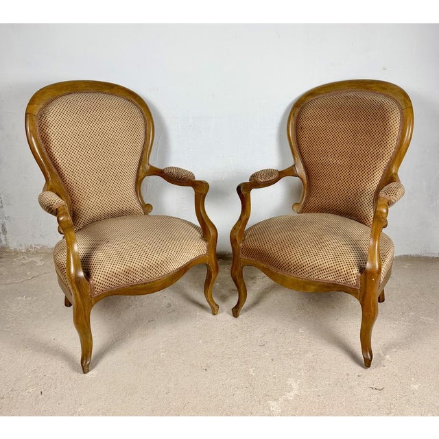 Elegant pair of Louis XV style bergère armchairs dating from approximately the 1950s, featuring graceful cabriole legs,...