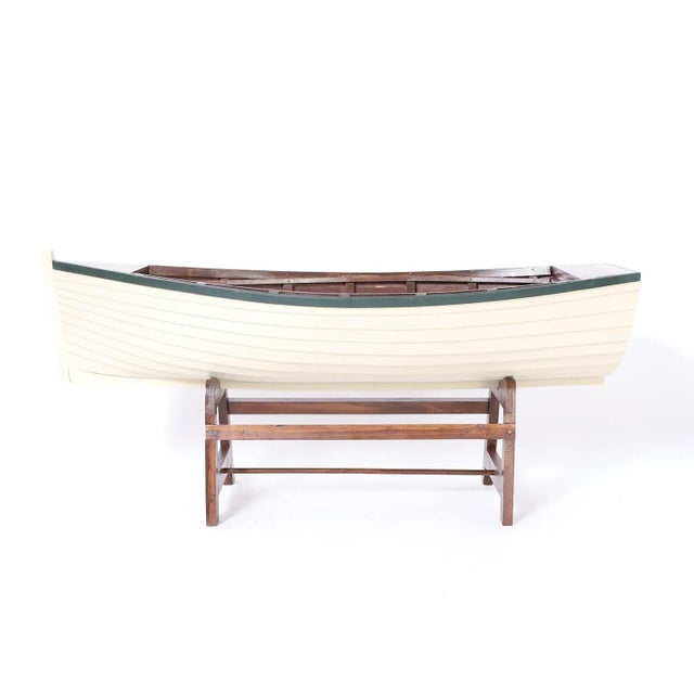 Vintage row boat model hand crafted in mahogany with ambitious accuracy. Painted white with green trim and presented in a...