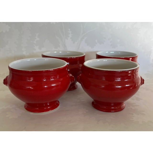 Beautiful set of four French soup bowls by Emile Henry, crafted in Marcigny, France,, small side handles, from high-fired...