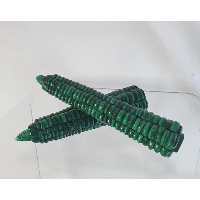 A pair of handmade corn on the cob in malachite intended for decoration. Wear consistent with age and use.