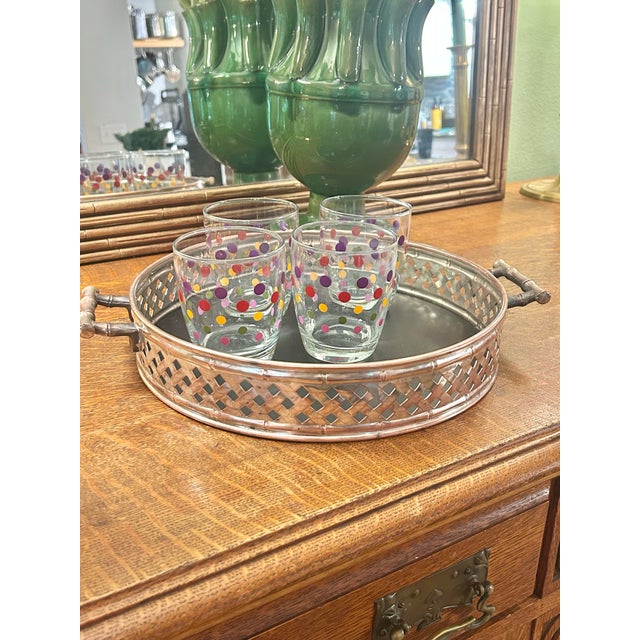 This is a vintage round gallery tray featuring a woven metal lattice surround and substantial faux-bamboo handles and...