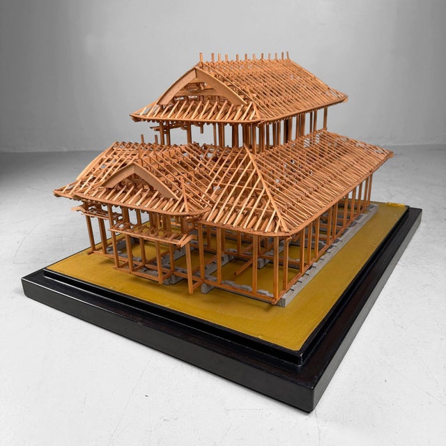 This distinctive Japanese piece is a finely crafted wooden scale model that reveals the structural framework and roof...