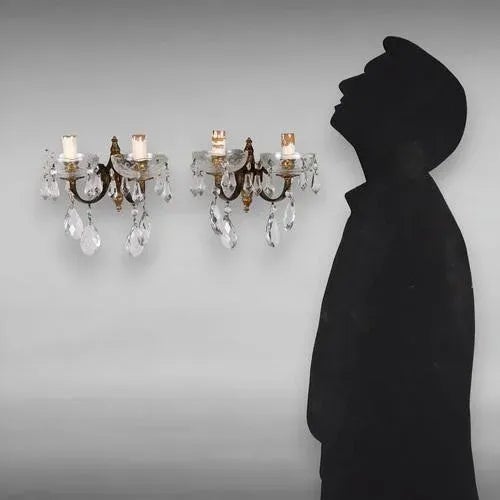 Pair of two-light gilded bronze appliques, Italy, 20th century. Bobeches and glass pendants. This piece is attributed to...