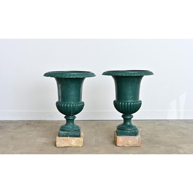A grand pair of late 19th century French cast iron “Medici urns” which display Neoclassical taste in their profile that...