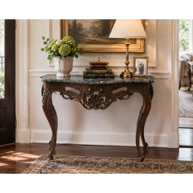 An exceptionally decorative Italian-made console table for Sherrill featuring an elaborately carved wood base and richly...