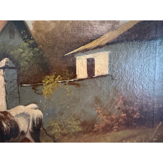 A charming antique original oil painting on canvas depicting two cows grazing in a quiet rural farm setting. Surrounded by...