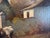 A charming antique original oil painting on canvas depicting two cows grazing in a quiet rural farm setting. Surrounded by...