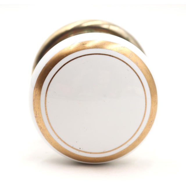 This Traditional vintage dummy door knob set includes a white and gold ceramic door knob and a polished brass rosette....